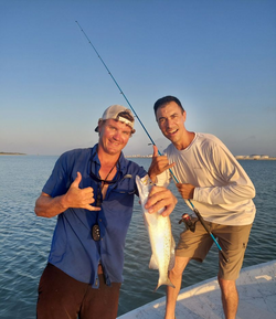Two anglers pose with their catch at Aransas Pass
