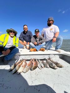 Successful fishing trip in Corpus Christi TX showing caught redfish on boat deck