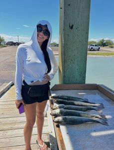 One person fishing with two fish in Texas