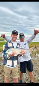 2 people fishing at Folly Beach