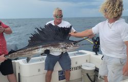 Two people fishing for an Atlantic Sailfish in Fernandina Beach