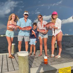 Two fishing enthusiasts enjoy a day on the water in Pensacola
