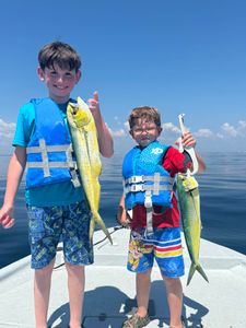Three people fishing with two big fish in Pensacola