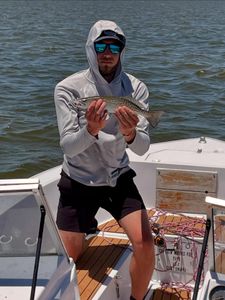 A person fishing for a spotted weakfish in Wanchese