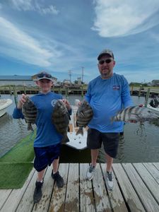Four black drum and sheepshead fish caught by two people fishing in Wanchese