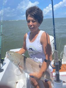 Fisherman holding large fish in North Carolina