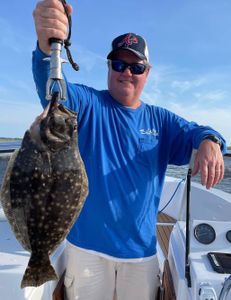 Photograph of a southern flounder, a 22-inch fish, caught in Wanchese