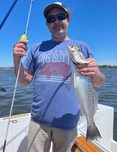 Angler proudly holding a spotted weakfish, 22 inches, caught while fishing in North Carolina