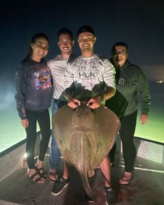 Four people fishing on the beach in Panama City Beach