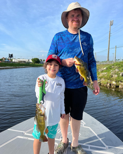 Two anglers holding two 14-inch fish in FL