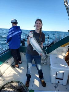 A fisherman holding a sea trout in NY