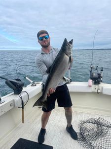 Angler posing with a 30-inch rainbow trout caught in Olcott