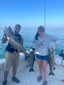 Two people fishing in Olcott with two big fish