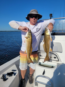 Angler holds two redfish caught in NC