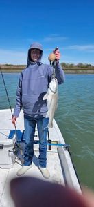 Angler holding caught fish on boat in Port O'Connor TX waters