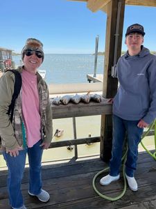 Fishing cleaning station at Port O'Connor TX with wooden dock structure overlooking water