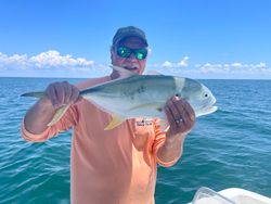 Single fisherman catching a 18-inch fish in Cape Coral
