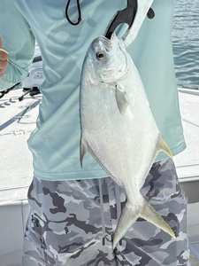Reeling in a Florida Pompano as clouds gather for afternoon rain!