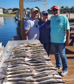 Three people enjoying a great fishing trip in Slidell