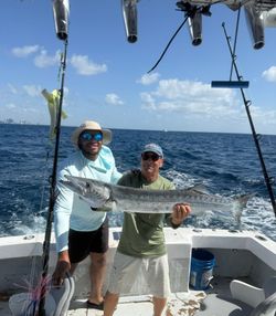 Two people fishing for a great barracuda in Miami Beach