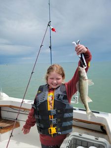 A fisherman holding an American Yellow Perch in Port Clinton