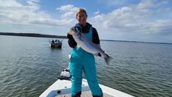 Striped bass fish caught by two people in Lexington