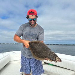 Fisherman catching a summer flounder in Jamestown
