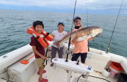 Three people on a cruise fishing in Norfolk