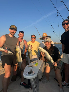 Four fishing boats at Norfolk harbor with six people on board enjoying a cruises and fishing adventure