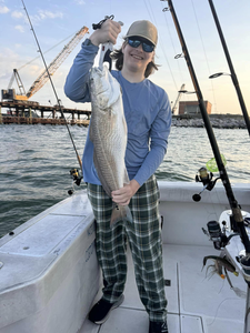 A fisherman holds a 19-inch redfish in Virginia