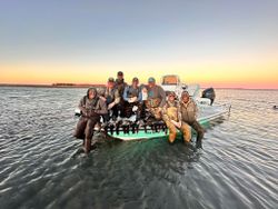 Fishing group on boat displaying their catch in Corpus Christi TX waters at sunset