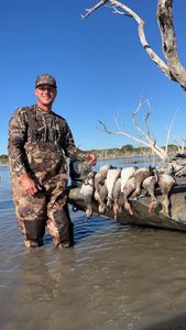 Successful duck hunting trip in Corpus Christi TX with multiple harvested waterfowl displayed on boat