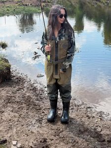 Angler with fishing rod standing by pond in Newport PA