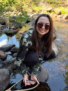 Freshly caught fish held in fishing net by rocky stream in Newport PA