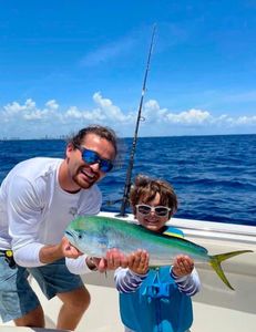 Mahi Mahi fish caught by two people in Miami Beach