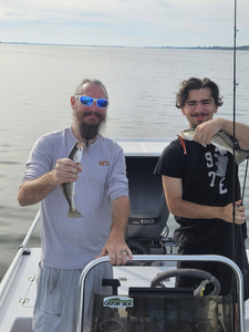 Two anglers with a small fish caught in Florida