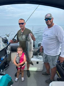 Successful Chinook salmon fishing trip on boat in Sackets Harbor NY with large catch displayed