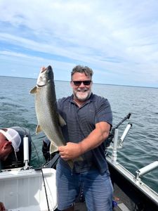 Angler fishing for a lake trout in NY