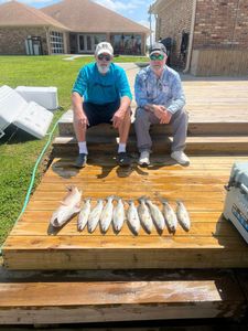 Three people fishing on a bridge in Bridge City