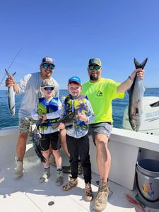 Successful fishing trip in Morehead City NC showing caught bluefish, black sea bass, and spanish mackerel on boat deck