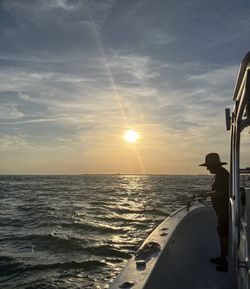 Fishing boat on ocean water at sunset in Morehead City NC