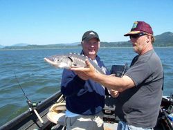 Two people fishing in Chehalis, with a 24-inch catch