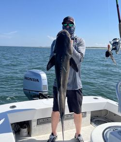 Fisherman reeling in catch in Norfolk