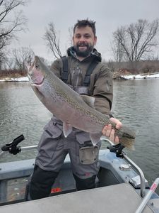 Angler with a large rainbow trout caught in MI