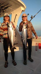 Two anglers fishing in Manistee with two big fish