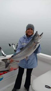 Chinook salmon being held by a fisherman in Manistee