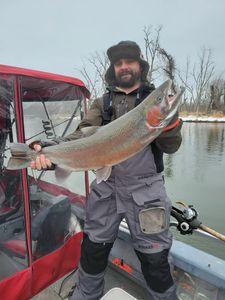Angler with a beautiful rainbow trout caught in MI