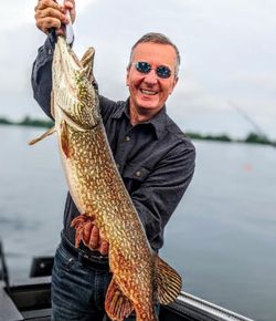 A person fishing in NY with a big fish