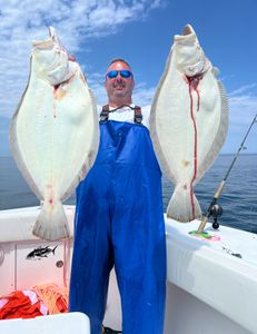 An angler with two big fish caught in Yarmouth