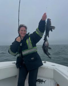 One person fishing with two fish caught in Yarmouth